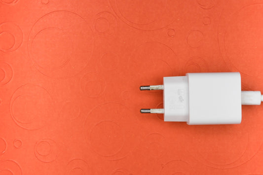 white adapter on pink surface